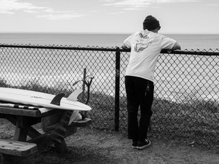 Professional skateboarder and surfboard shaper, Zak Miller, checking the waves in Carlsbad, California.