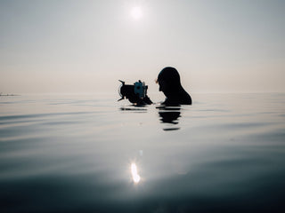 A water photographer taking pictures of surfers in the North Sea.