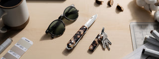 The Eco-Acetate collection of pocket tools on a desktop.