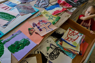 An art student overlooking all of the classes work.