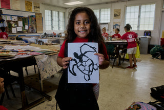 An art student of Kahuku elementary school showing her turtle painting.