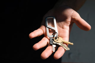 A person with the Madison carabiner in their palm.