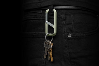 The Madison keychain carabiner hanging from a belt loop.