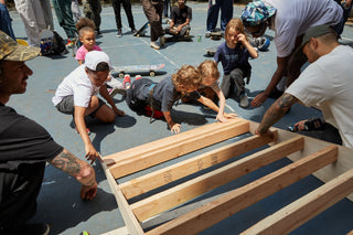 Kids helping build a skate ramp.
