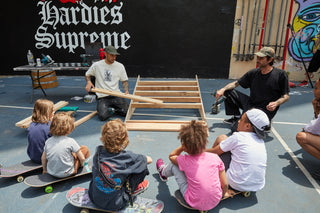 Kids learning to build a skate ramp.