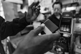 Professional skateboarder Beatrice Domond using her Lowe wallet at a NYC bodega.