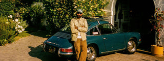 Aaron Ashton leaning against his Porsche.