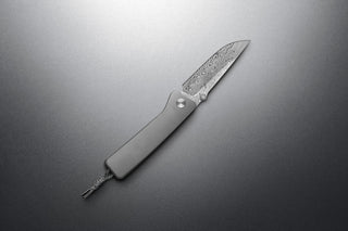 The Barnes integral pocket knife on a steel surface.