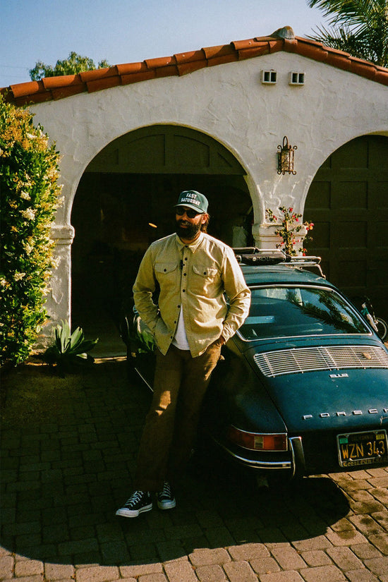 Aaron Ashton leaning against his Porsche.
