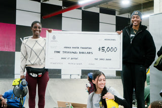 Beatrice Domond handing over a big check to the Harold Hunter Foundation from The James Brand Make it Better program.
