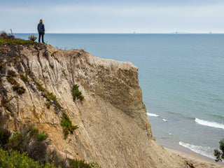 Professional surfer Connor Coffin checking the surf from a cliff in Santa Barbara, Californina.