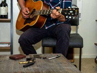 Professional surfer Connor Coffin playing guitar at home.
