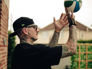Professional barber Paul Hewitt shooting a basketball.