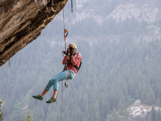 Professional rock climber and photographer Savannah Cummins taking a photo of another photographer.